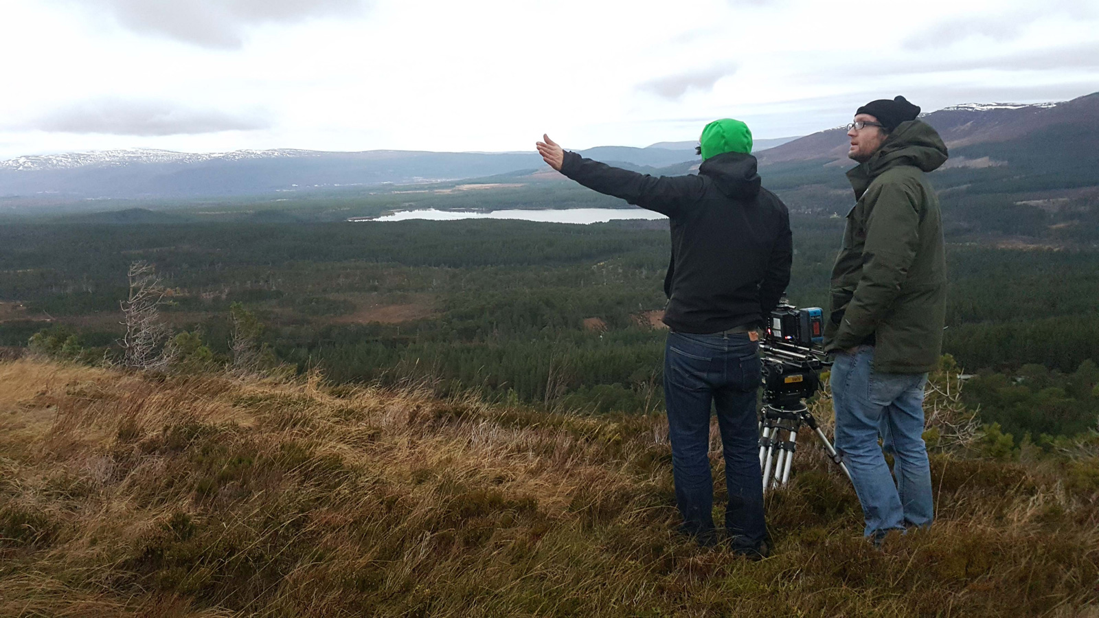 Calibre filming on location - two people stand on a hillside in Scotland with a tripod